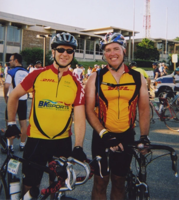 two bicyclists standing in front of the camera