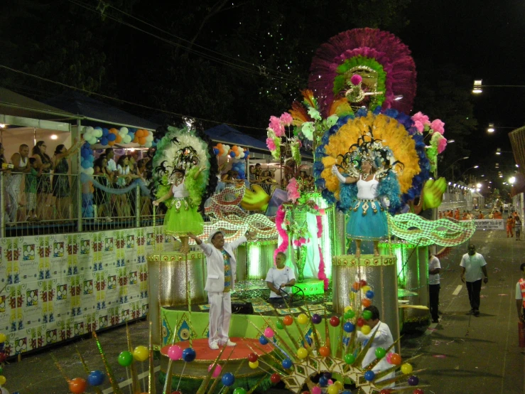 parade float in dark street with lights and decorations