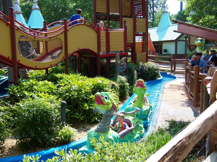 a large water slide filled with children playing on a cloudy day