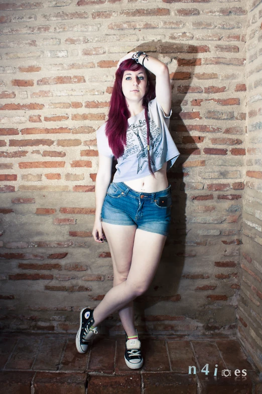 a young woman with red hair poses for a pograph