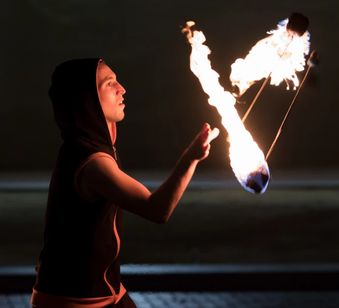 girl holding onto fire spinning with a glowing handle