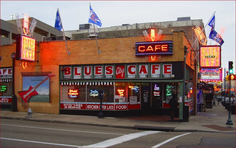 a restaurant with neon signs in front of it