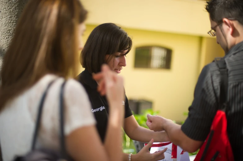 two young people are sitting next to a woman at a table