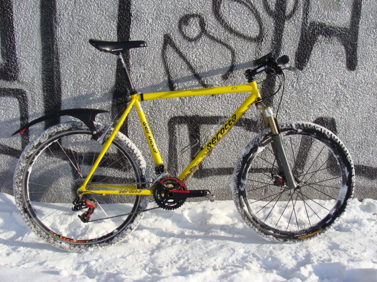 a bike standing on a snow covered ground