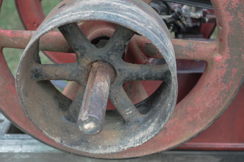 a rusted metal tire sitting on top of a wooden floor