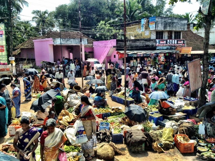 a crowd of people with backpacks are standing outside of a market