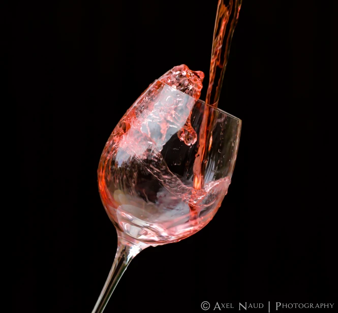 a glass of wine being poured into it