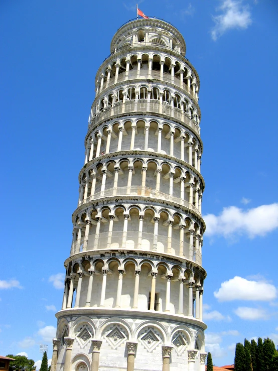 a very large tall leaning tower with statues on top