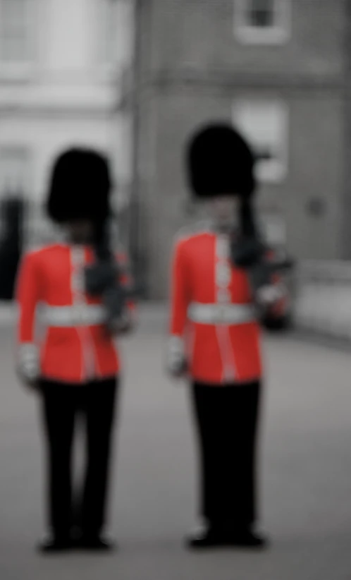 the back of two guard's uniforms standing on a city street