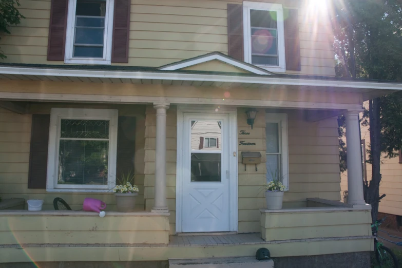 a house with a porch and white front doors