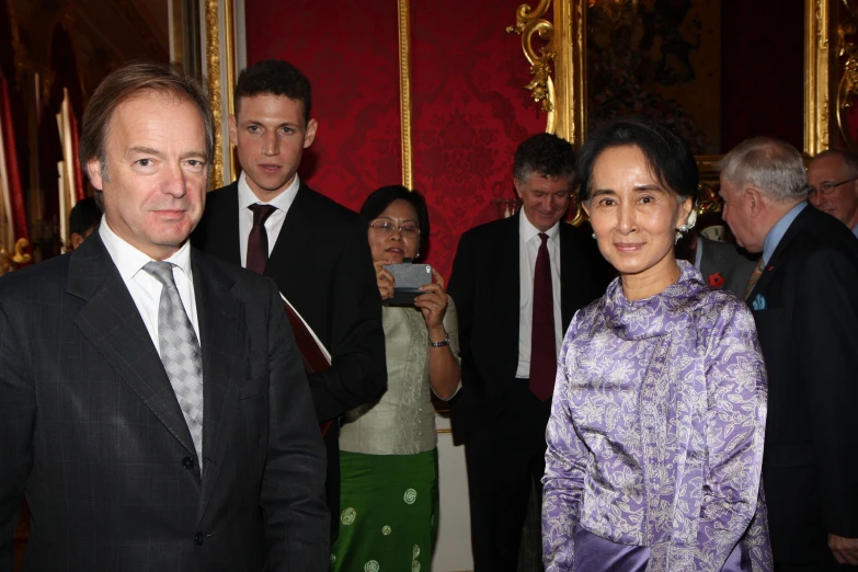 people standing together, some in a suit and tie