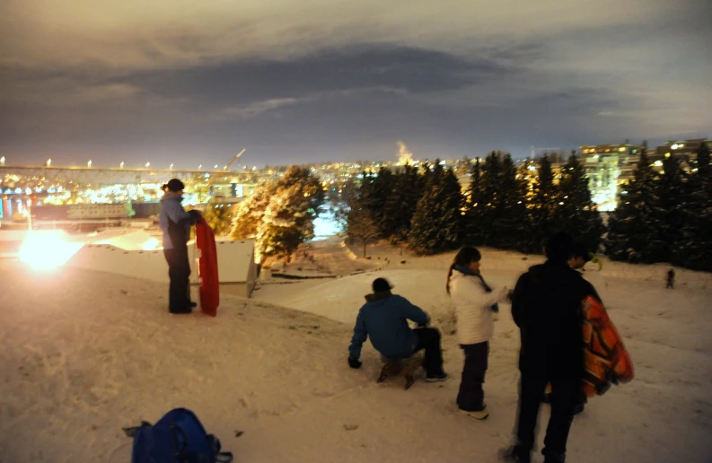 a group of people that are sitting on a snowboard