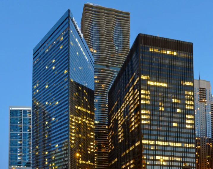 two big building in the middle of a city at night