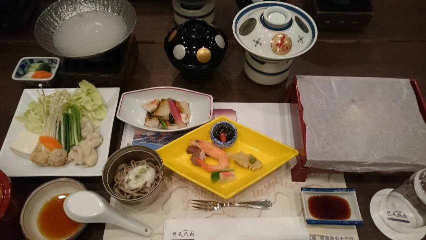 a tray is holding some food and dishes