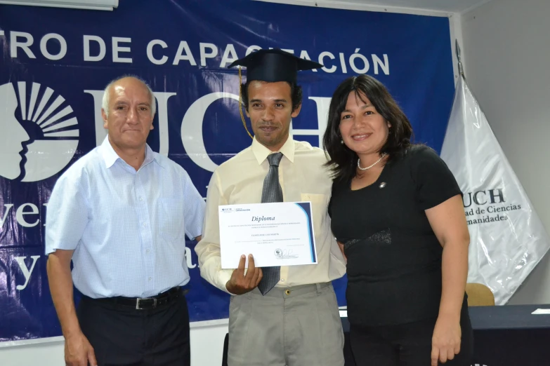 a man in a cap and a woman holding a diploma