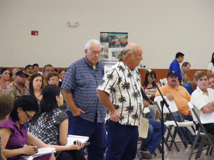 the two men are standing at the microphone