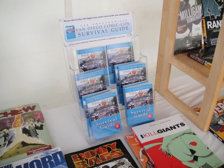 an assortment of comic books are displayed on a white surface