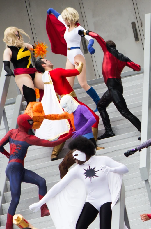 a group of women in costumes climbing stairs