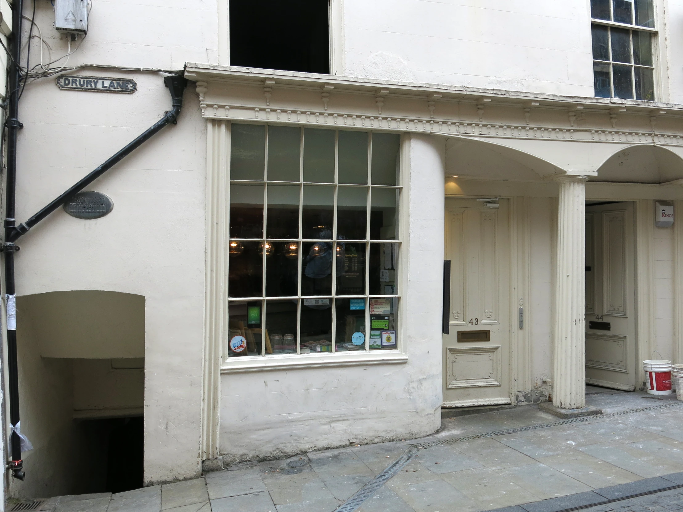 a couple of white doors and windows on a building