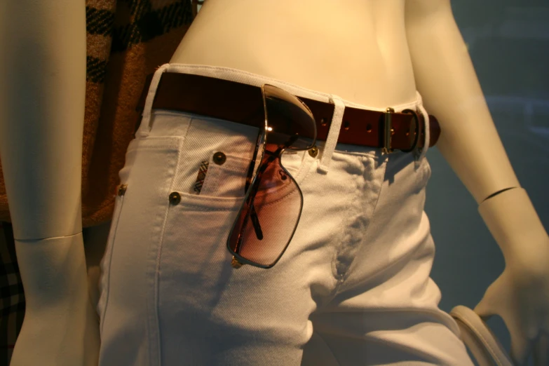 the belted shirt features a pair of sunglasses on its left side