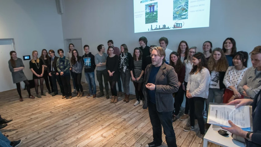 a man is giving a presentation to students