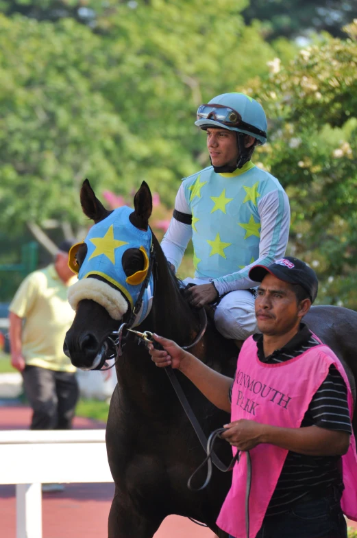 a man sits atop the back of a horse