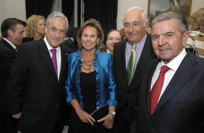 a group of people in suits posing for a picture