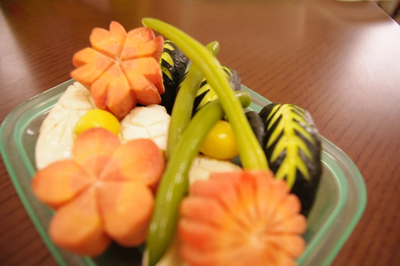 a green bowl filled with different types of fruit