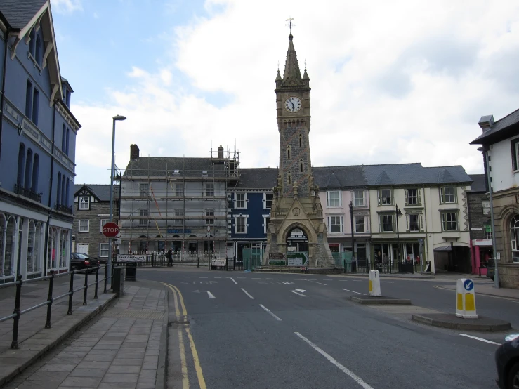 an old clock tower is seen in the middle of the town