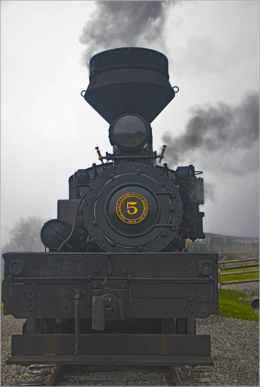 an old steam locomotive moving through a country