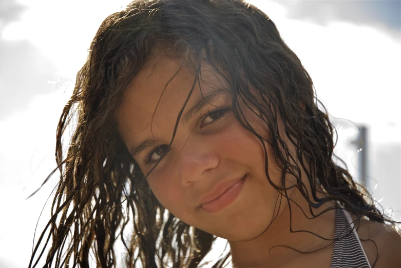 a little girl with wet hair smiling