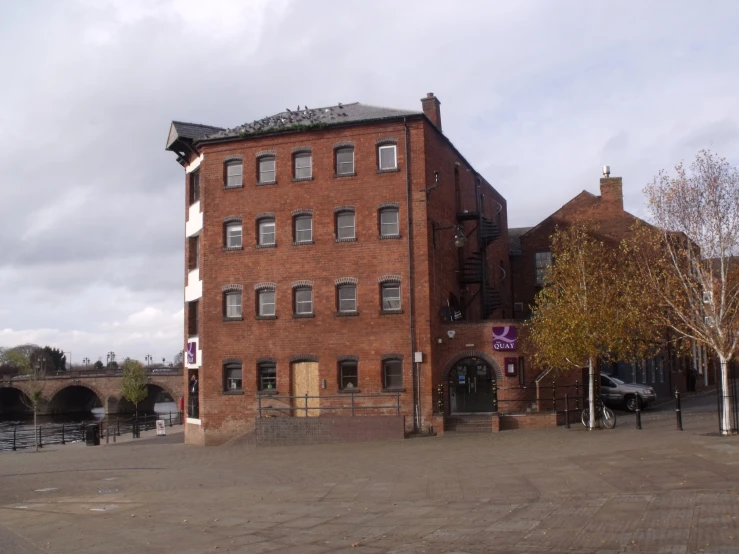 a large brick building on a cloudy day