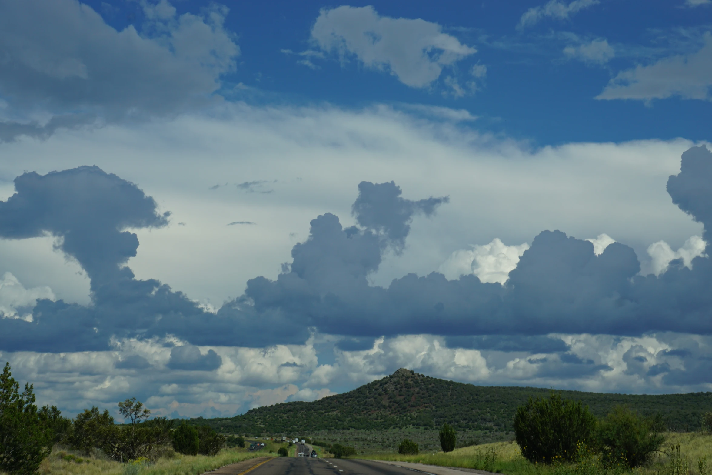 the cloudy sky over a mountain has been reflected in the car