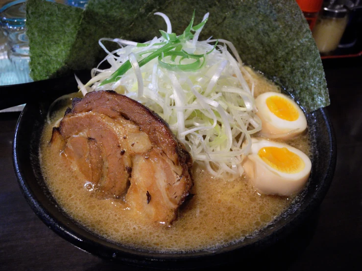 there is a large bowl of food with noodles and meat