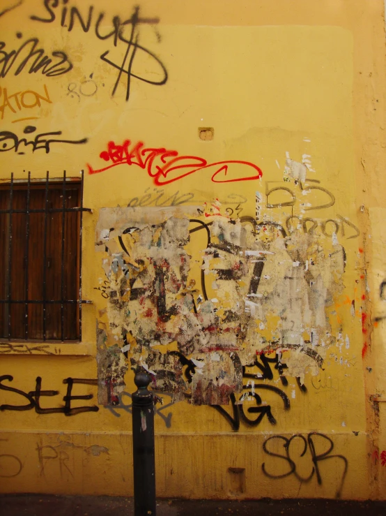 the walls are covered with graffiti and have bars on them