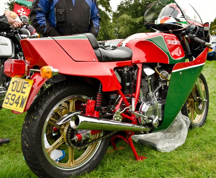 a motorcycle with two people next to it