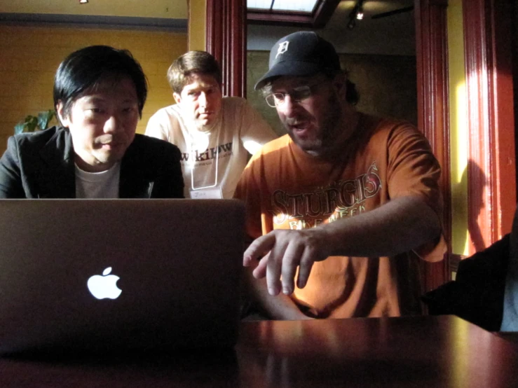 a couple of guys working on a laptop computer