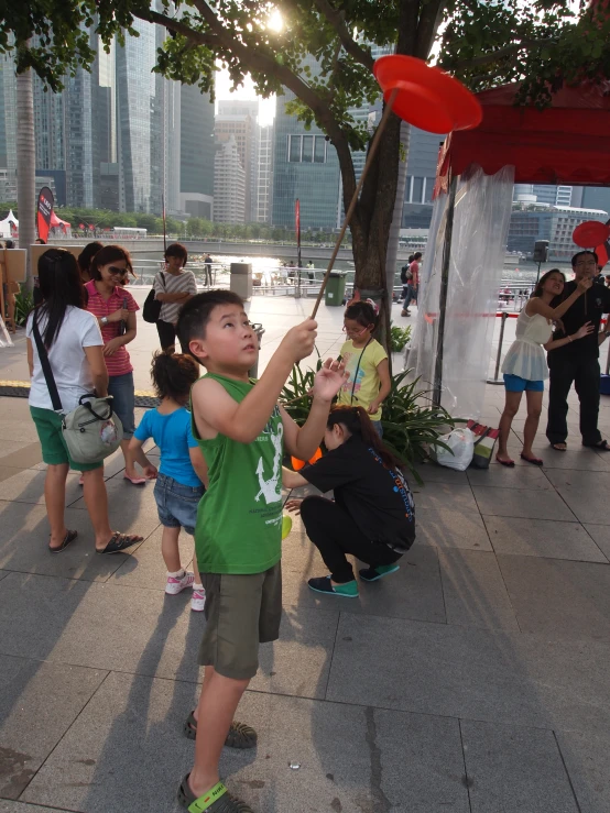 the young children are playing with their flying discs