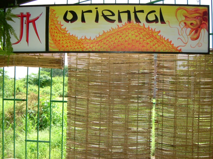 a window covered in bamboo and an oriental sign