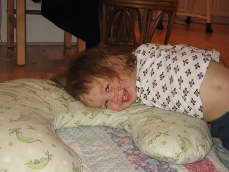 a young child is laying on a pillow