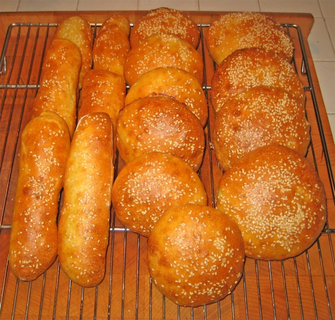 large variety of bagels cooling on the rack
