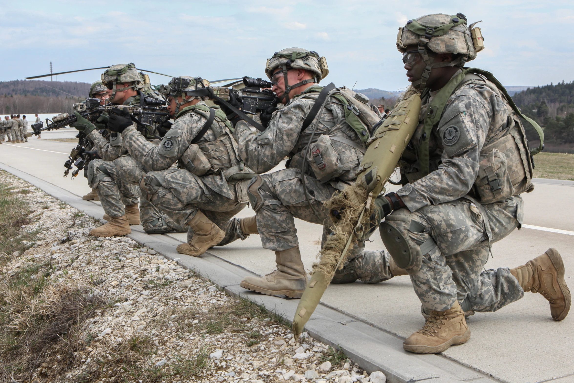 a group of soldiers carrying rifles down a street