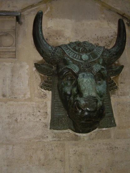 a bull is wearing an ornate bronze head