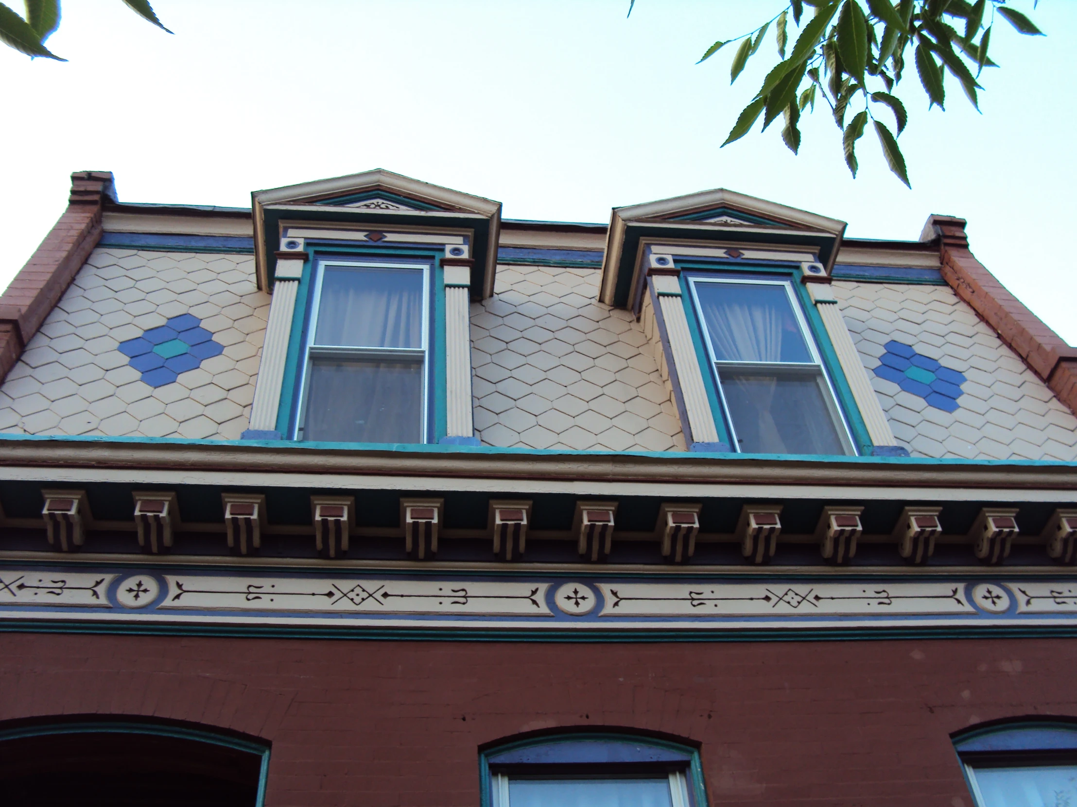 a brick building with some blue and white decoration