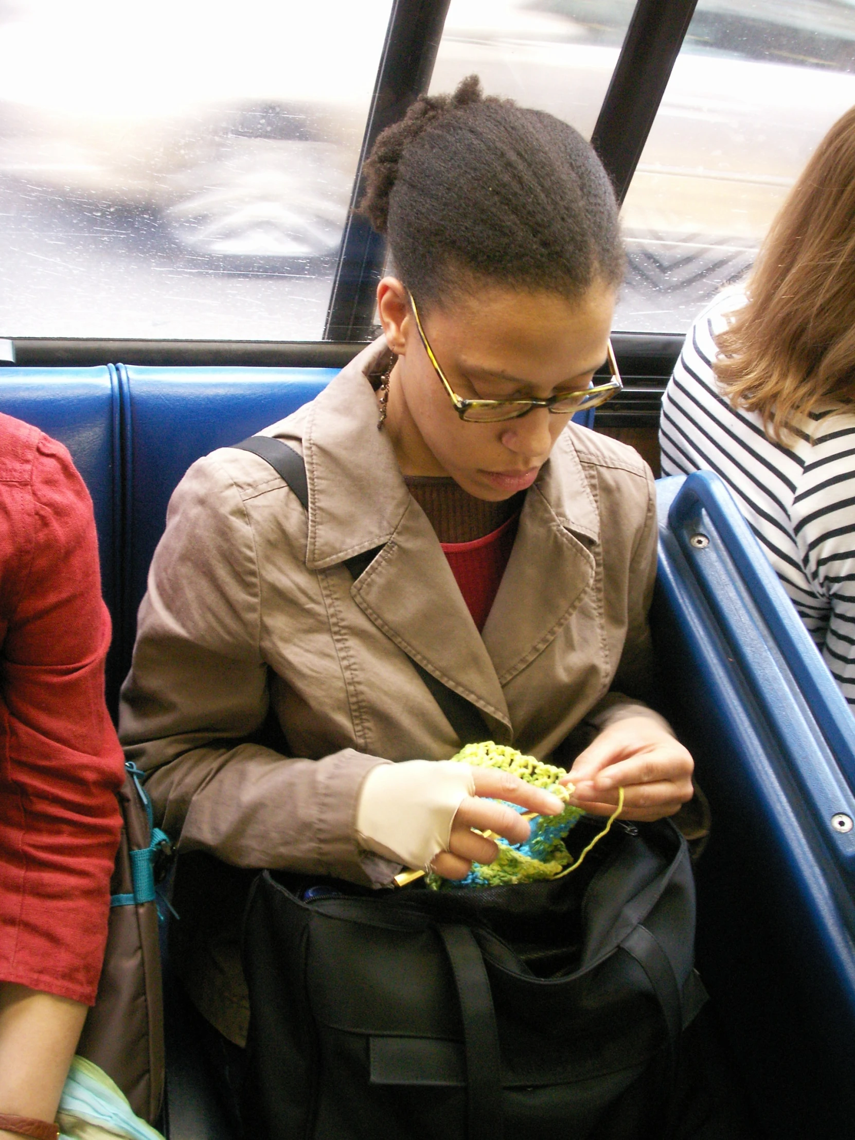 a young woman is looking down at her handbag