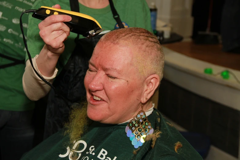 a woman being shaved with an electric shave