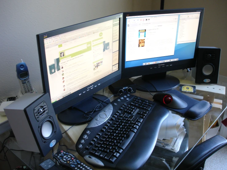 a desk that has two computers on it