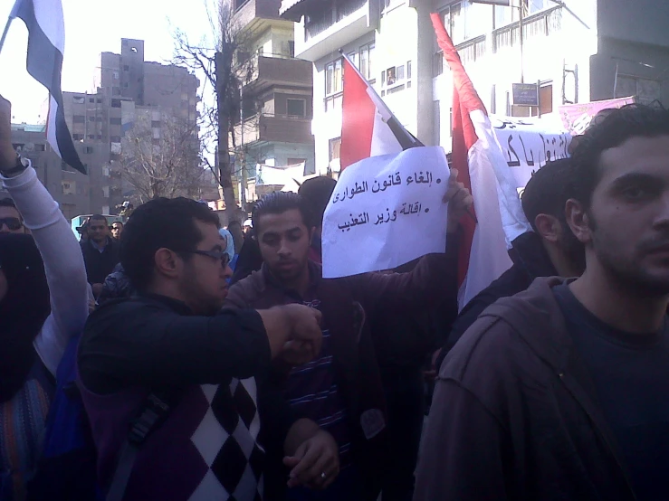 a group of people holding up signs and banners