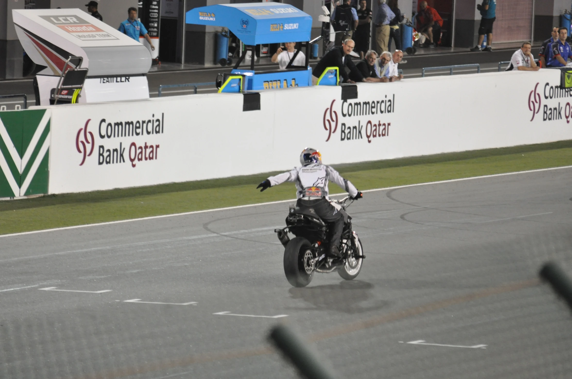 a man riding on the back of a black motorcycle