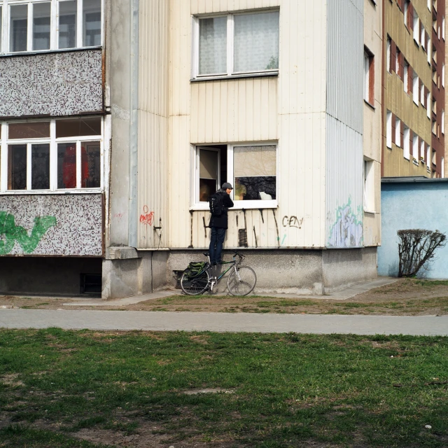 there is a building with one man standing in the window